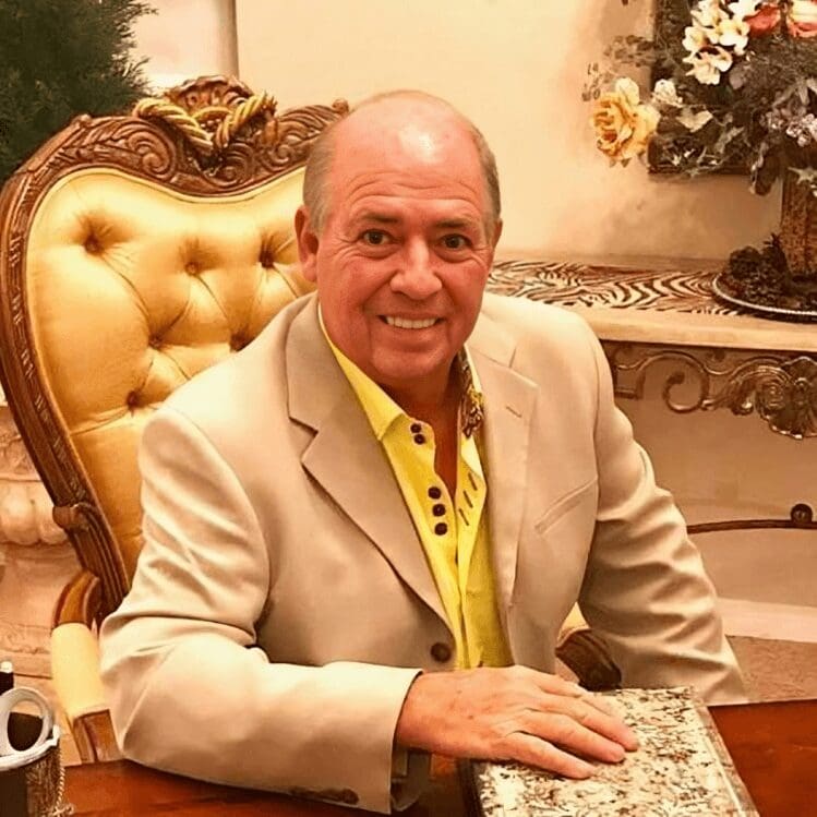 A man sitting at a table with a book.